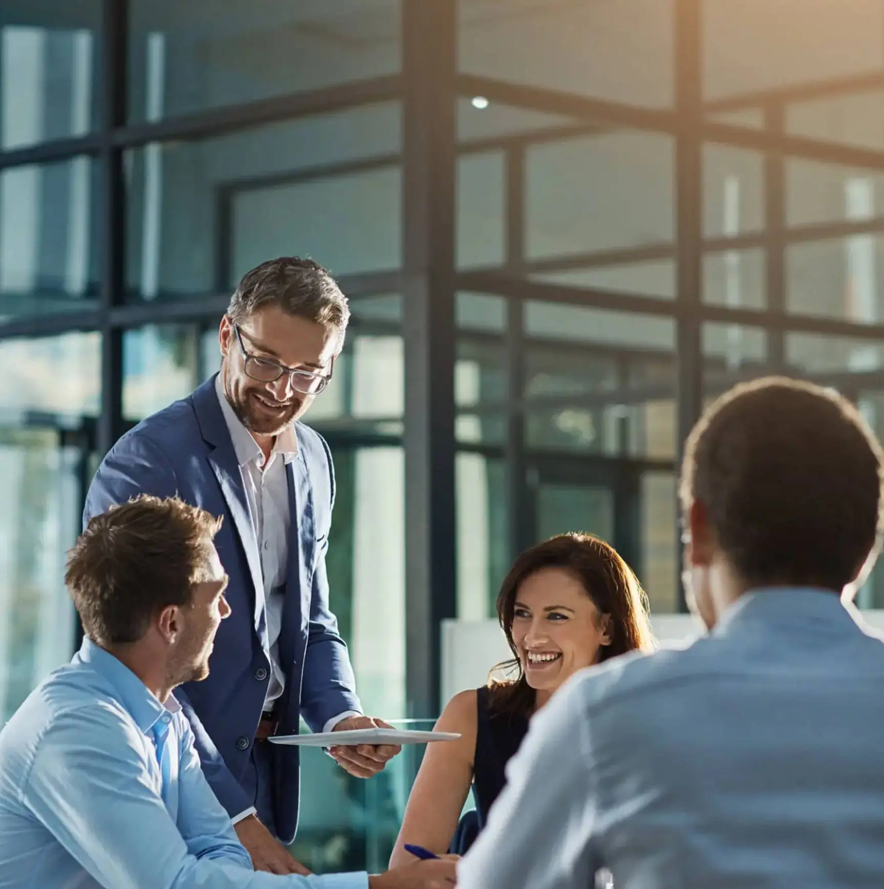 Business meeting with smiling colleagues interacting.
